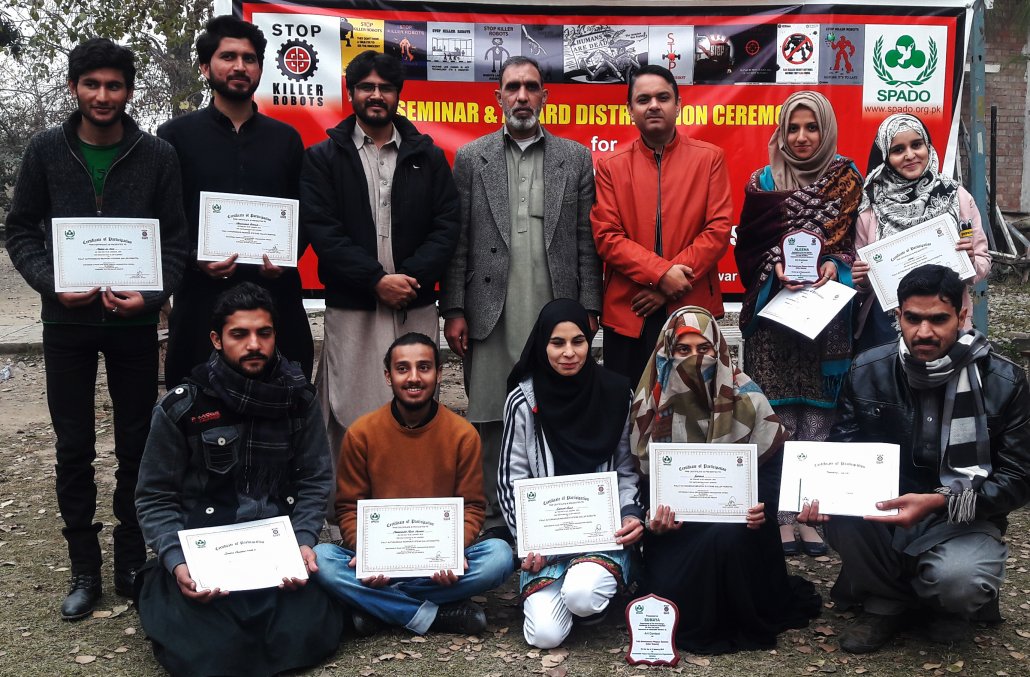 A group photo of Contest Winners and special mentions with Chairman Department of Art & Design & Regional Director SPADO, during Award Distribution Ceremony at University of Peshawar, SPADO Art Contest to Stop Killer Robots